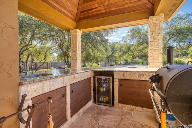 view of patio / terrace with sink, beverage cooler, and grilling area