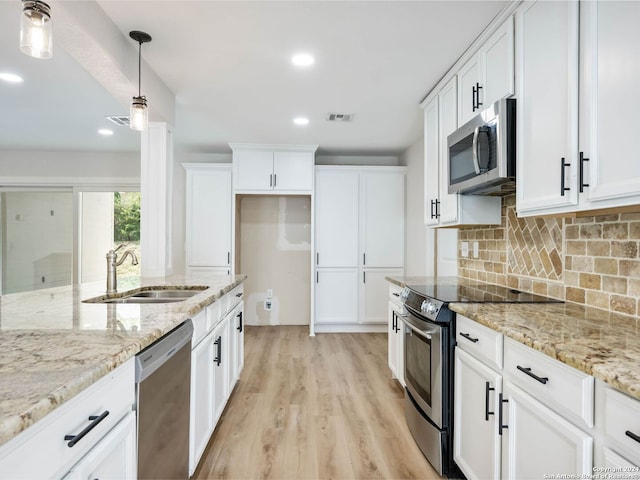 kitchen featuring light hardwood / wood-style flooring, stainless steel appliances, sink, and white cabinets