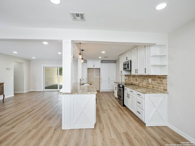 kitchen featuring light wood-type flooring, sink, appliances with stainless steel finishes, and white cabinetry