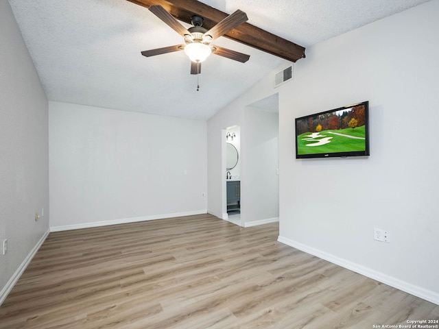 unfurnished living room featuring a textured ceiling, light hardwood / wood-style flooring, ceiling fan, and vaulted ceiling with beams