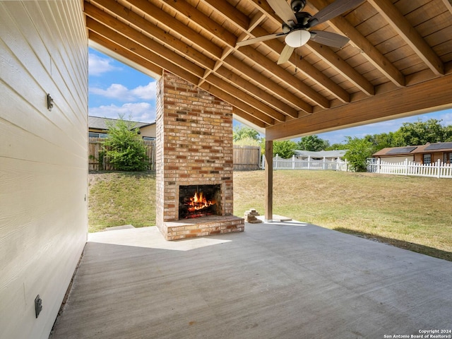 view of patio / terrace featuring an outdoor brick fireplace and ceiling fan