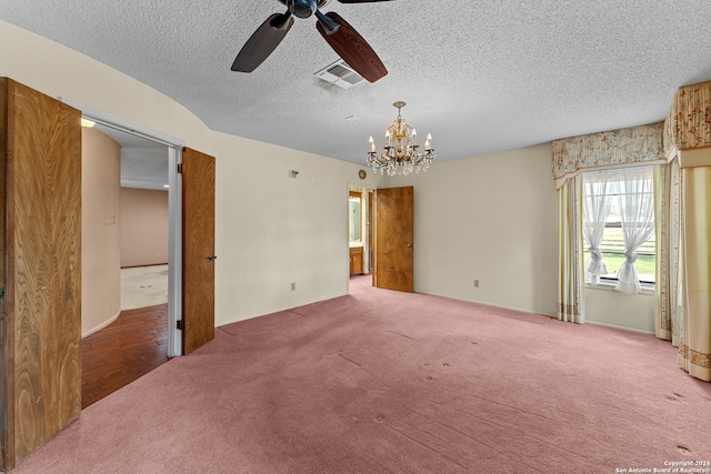 unfurnished bedroom featuring a textured ceiling, carpet, and ceiling fan with notable chandelier