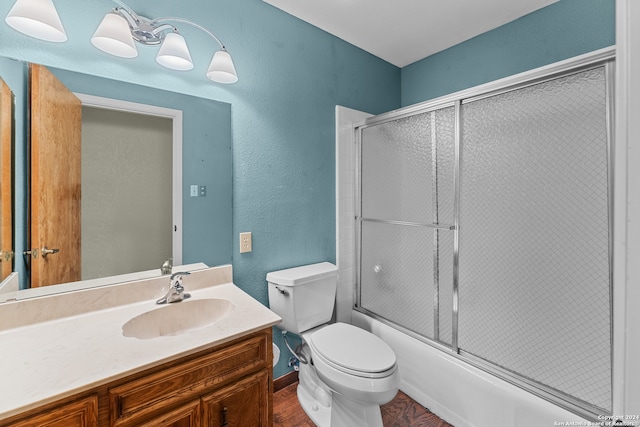 full bathroom with hardwood / wood-style floors, enclosed tub / shower combo, toilet, and vanity