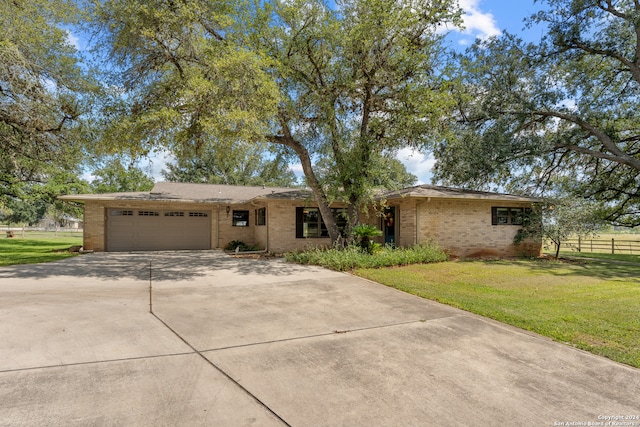 ranch-style home with a front lawn and a garage