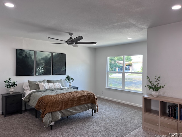 bedroom featuring ceiling fan, carpet, and a textured ceiling