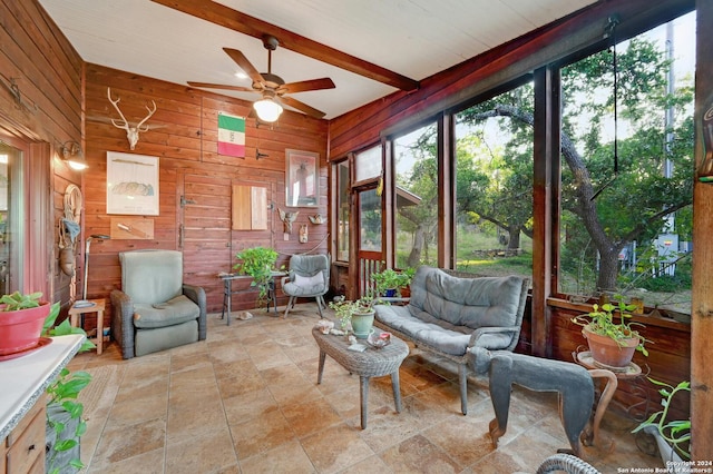 sunroom / solarium with ceiling fan and beam ceiling