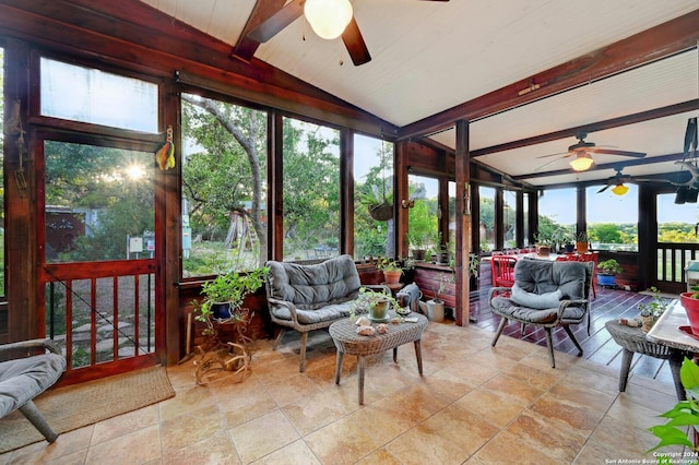 sunroom / solarium with lofted ceiling with beams, a healthy amount of sunlight, and ceiling fan