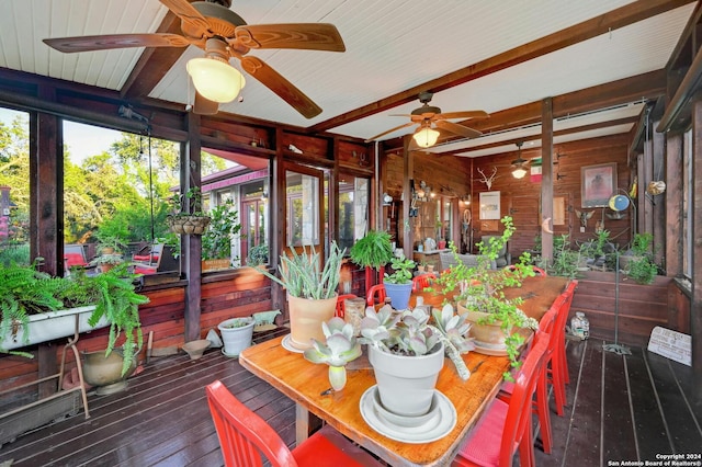 sunroom / solarium with ceiling fan and beam ceiling