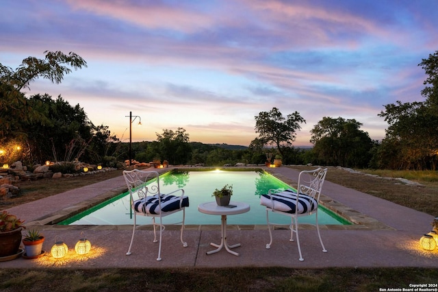 view of pool at dusk