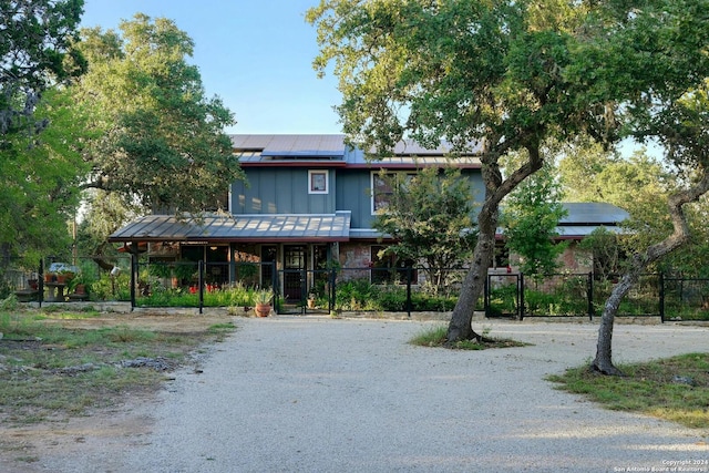 view of front facade featuring solar panels