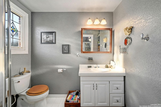 bathroom with vanity, toilet, and tile patterned floors