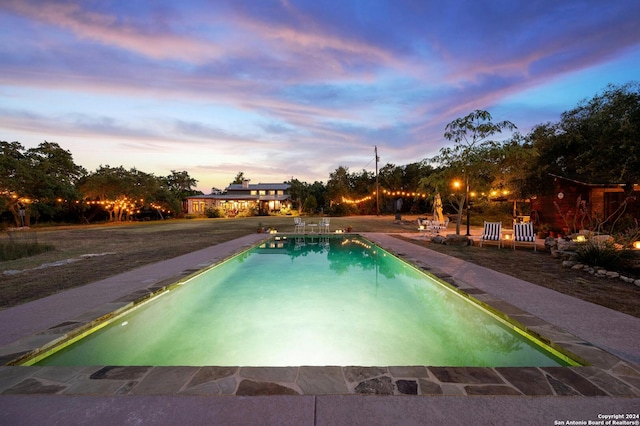 view of pool at dusk