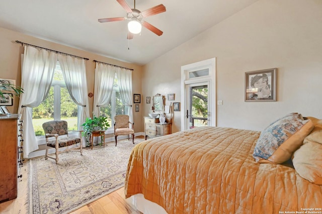 bedroom featuring lofted ceiling, light hardwood / wood-style floors, ceiling fan, and access to outside