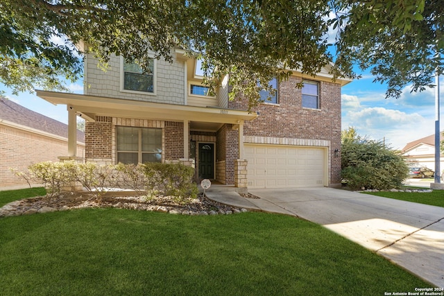 view of front of home featuring a front yard and a garage