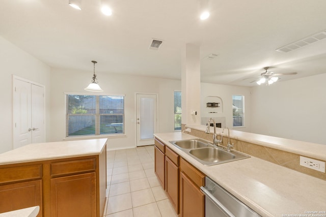 kitchen featuring sink, hanging light fixtures, ceiling fan, light tile patterned floors, and a kitchen island