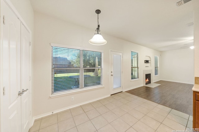 interior space with light wood-type flooring and ceiling fan