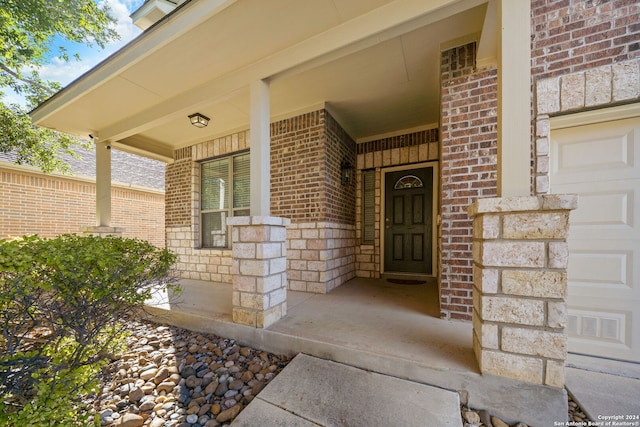 view of exterior entry with a porch