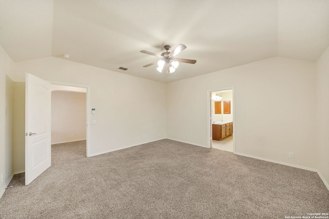 carpeted spare room with ceiling fan and lofted ceiling