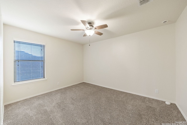 spare room featuring ceiling fan and carpet floors