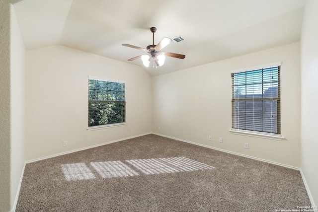 spare room featuring carpet, ceiling fan, and lofted ceiling