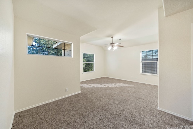 spare room with ceiling fan, carpet floors, and a wealth of natural light