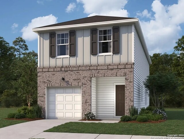 view of front of property featuring a garage and a front lawn