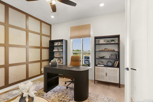 home office featuring light hardwood / wood-style flooring and ceiling fan