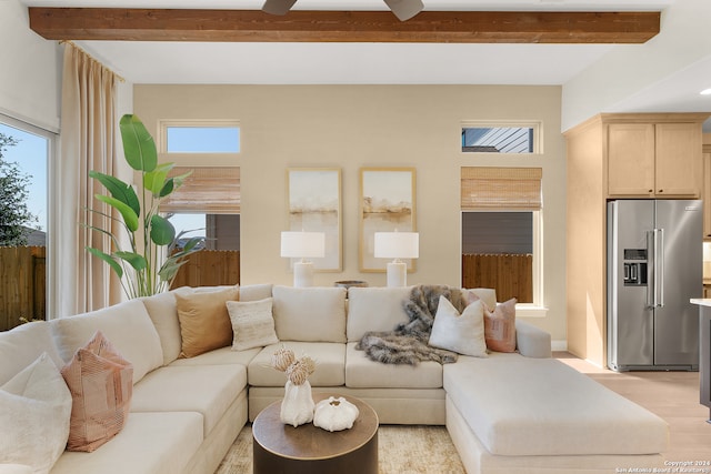 living room with beamed ceiling, a wealth of natural light, light hardwood / wood-style flooring, and ceiling fan