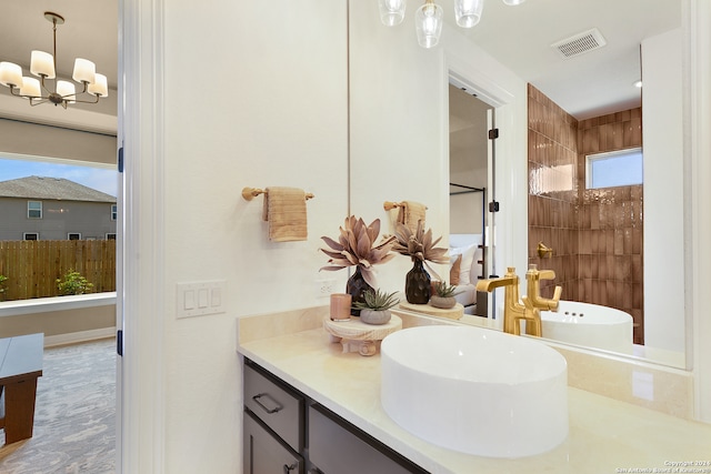 bathroom with separate shower and tub, a chandelier, and vanity