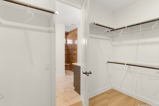 walk in closet featuring light hardwood / wood-style floors