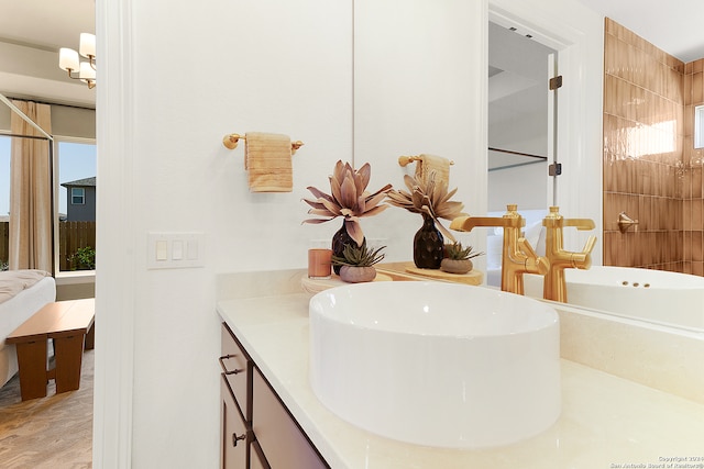 bathroom featuring vanity and a notable chandelier