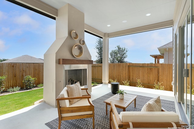 sunroom / solarium with an outdoor fireplace and plenty of natural light