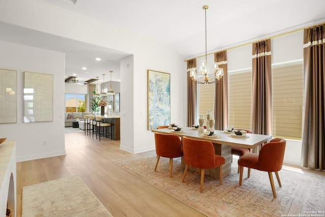 dining area featuring light hardwood / wood-style flooring and a notable chandelier