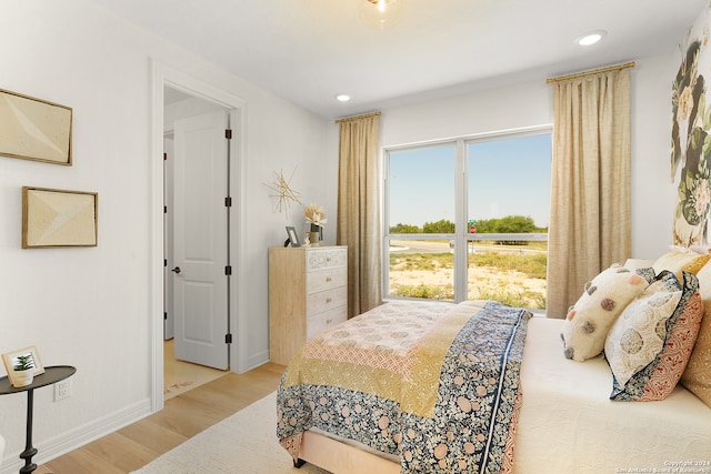 bedroom featuring light wood-type flooring and multiple windows