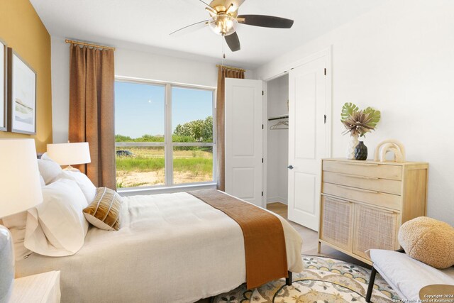 bedroom with ceiling fan, a closet, and wood-type flooring