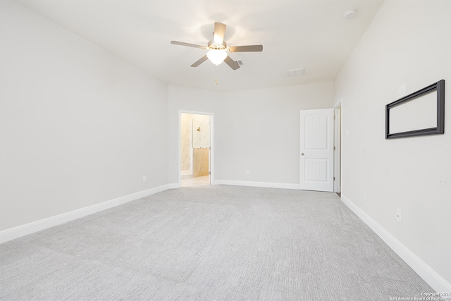 empty room featuring ceiling fan and light carpet