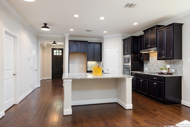 kitchen featuring a kitchen island, dark hardwood / wood-style floors, stainless steel appliances, and light stone counters