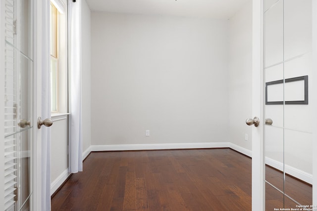 empty room with dark wood-type flooring