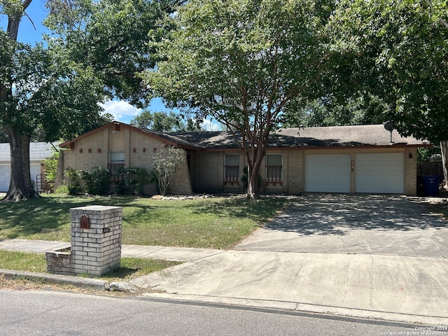 ranch-style house with a front yard and a garage