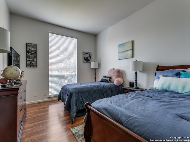 bedroom with hardwood / wood-style flooring