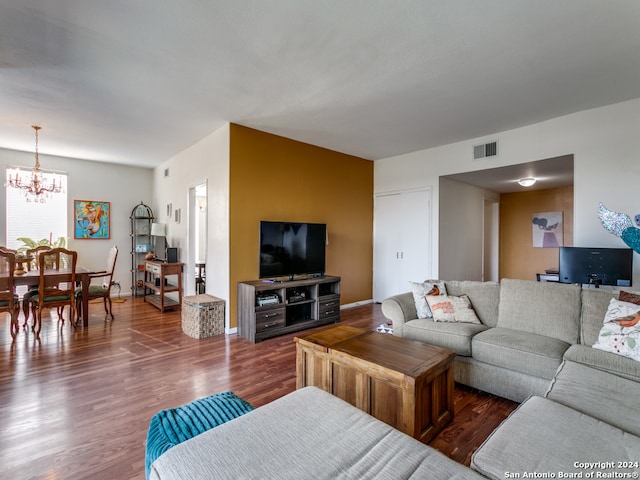 living room featuring dark hardwood / wood-style flooring and a chandelier