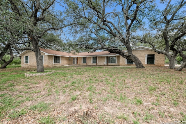 rear view of property featuring a lawn