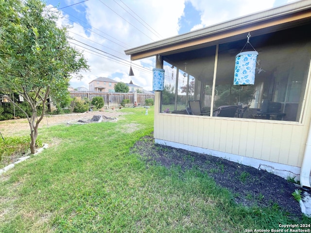 view of yard featuring a sunroom