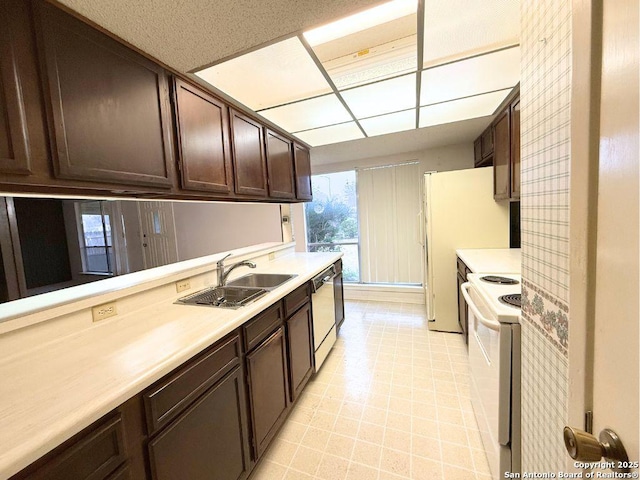 kitchen with white appliances, sink, and dark brown cabinets