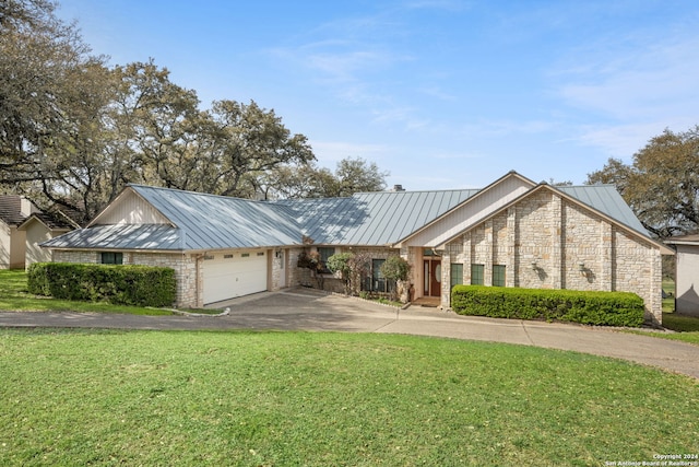 view of front of home with a garage and a front yard