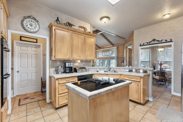 kitchen featuring light brown cabinetry, a healthy amount of sunlight, a center island, and sink