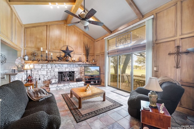 living room with ceiling fan, beamed ceiling, high vaulted ceiling, and a fireplace