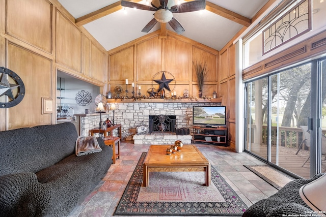 living room with a wealth of natural light, ceiling fan, high vaulted ceiling, and a fireplace