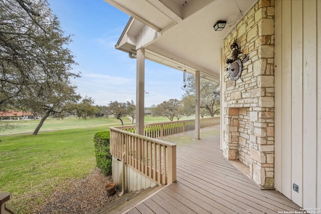 wooden terrace featuring a yard