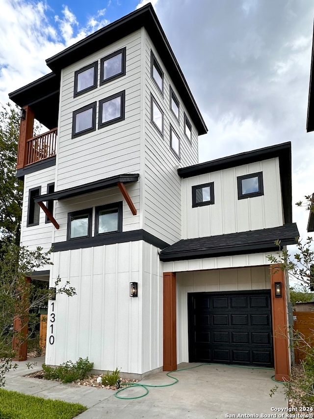 view of front of property with a garage and a balcony